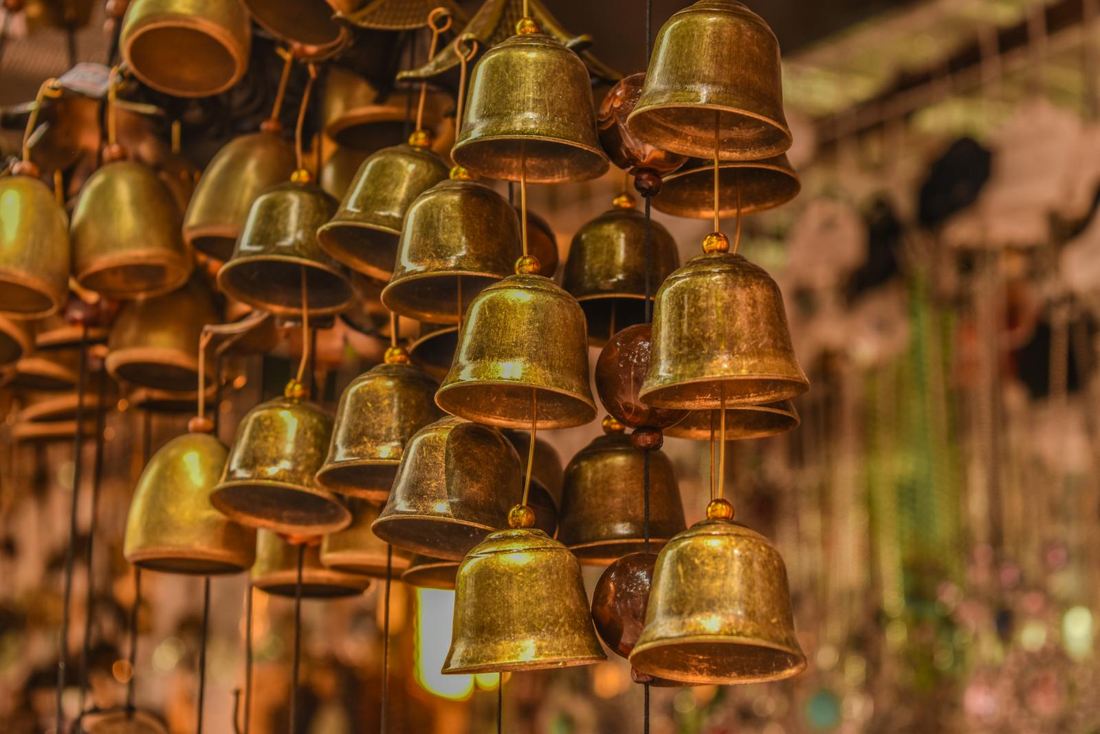 Detailed close-up of hanging brass bells used as decorative ornaments.